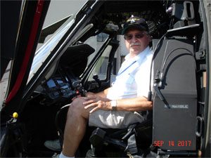 Joe Kowalczyk sitting in a Blackhawk Helicopter