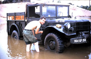 Derrol "Tex" Wells washing Avionics truck