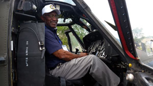 Bob Brown seated in a Blackhawk Helicopter